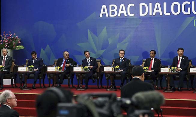 President Moon pushes people-centered economy at APEC